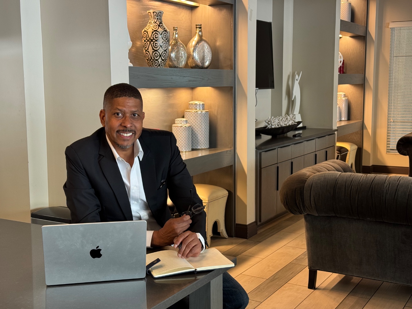Carlton Hill at his desk, Money Coach and Former Banking VP
